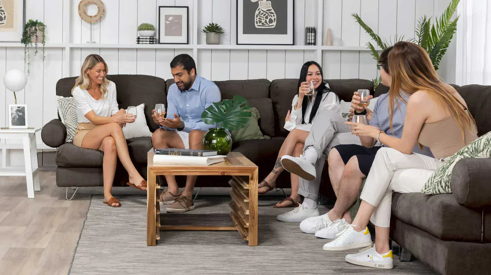 Friends sitting on a modern sectional couch.